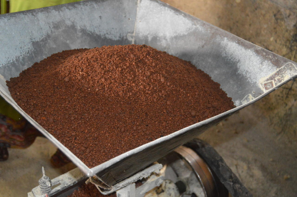 Crushed shea nuts being processed into the pure and nourishing shea butter by 3CayG