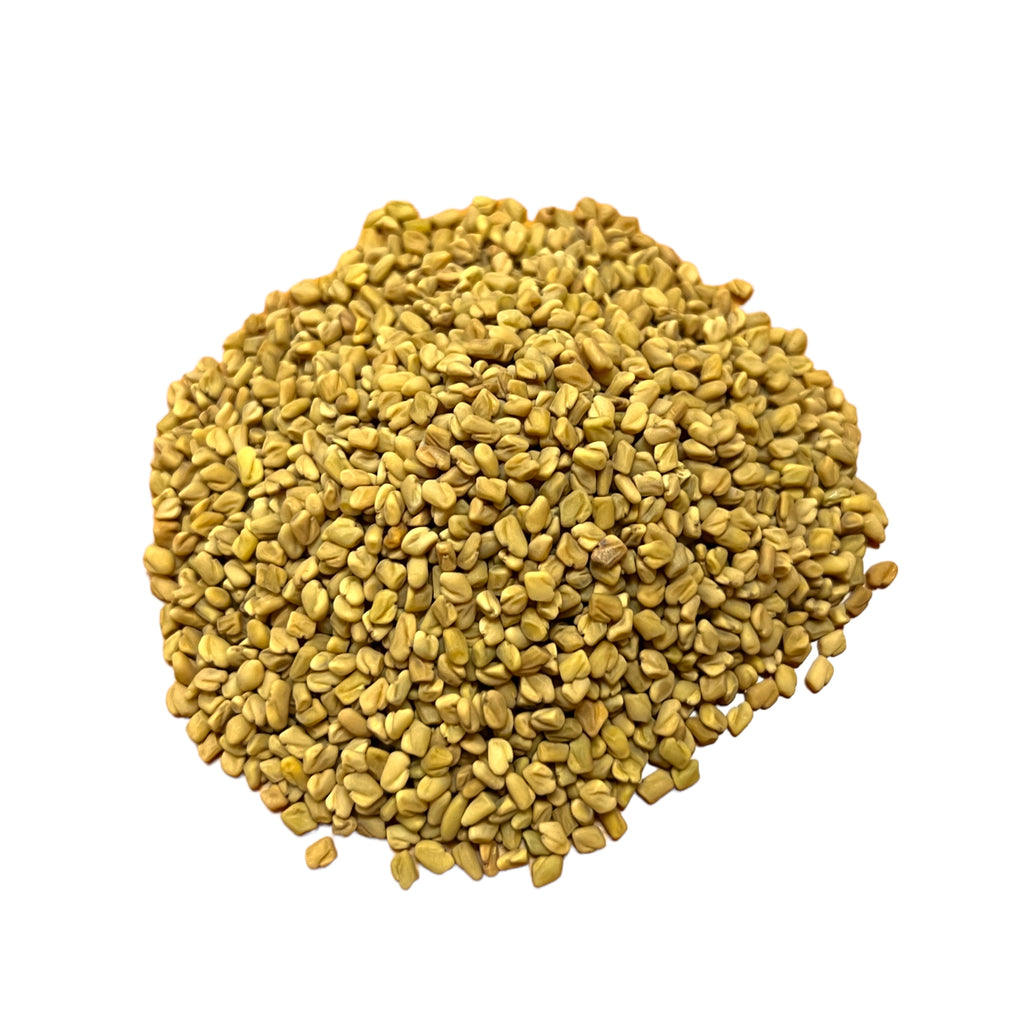 A pile of golden-brown Fenugreek Seeds on a white background