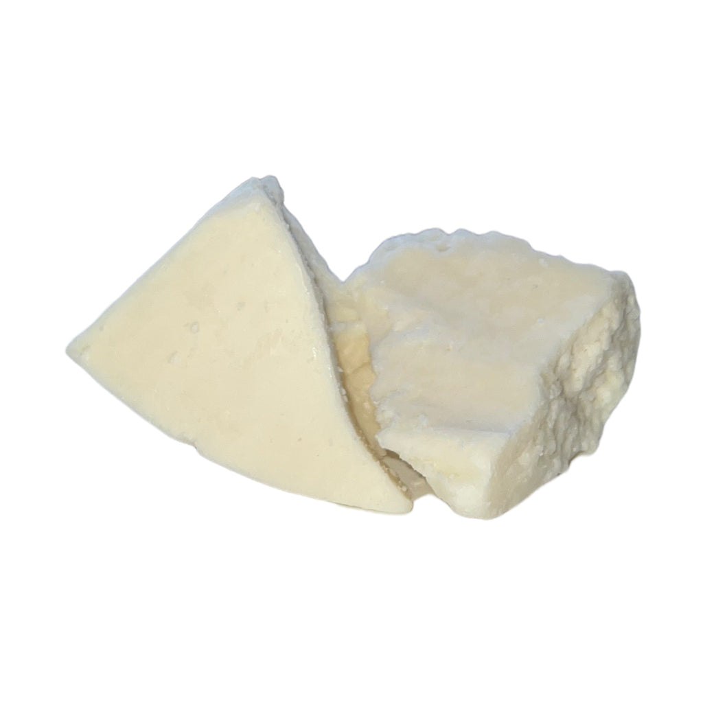 A piece of pure, white and unscented refined cocoa butter, ready to be used in your skin care routine for silky smooth skin