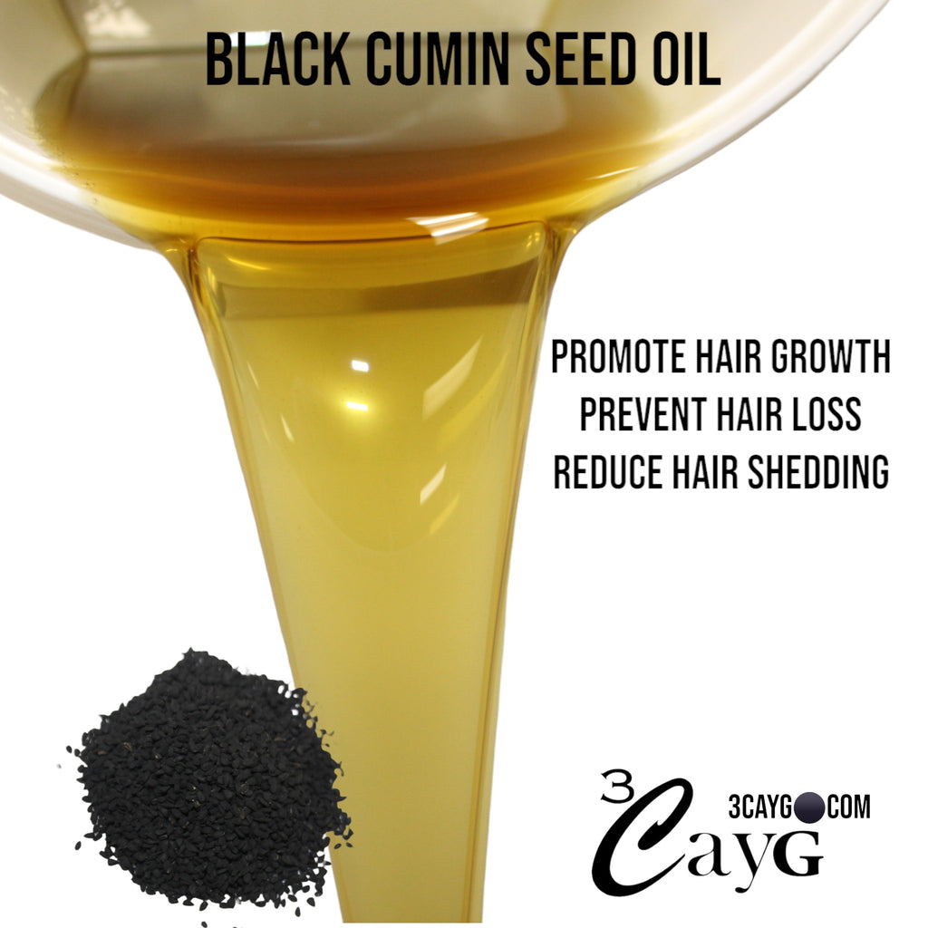 A bottle of cold-pressed black seed oil and whole black cumin seeds on a white surface